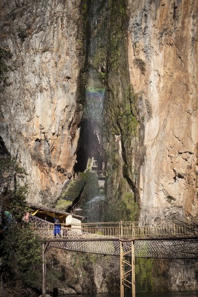Naxi woman, waterfall and bridge